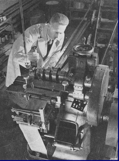 Het voor de anode bestemde, op breede rollen gewikkelde bladmetaal wordt met behulp van deze machine op de gewenschte lengte gesneden. Foto 1939.